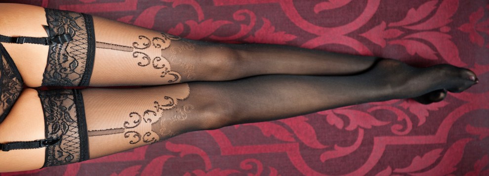 Long legs in black stockings and panties indoor shot. Sexy woman legs.